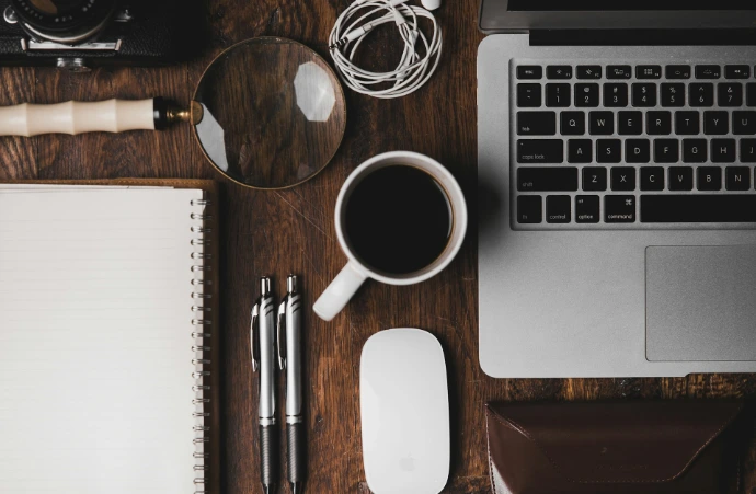 cup of coffee near MacBook Pro